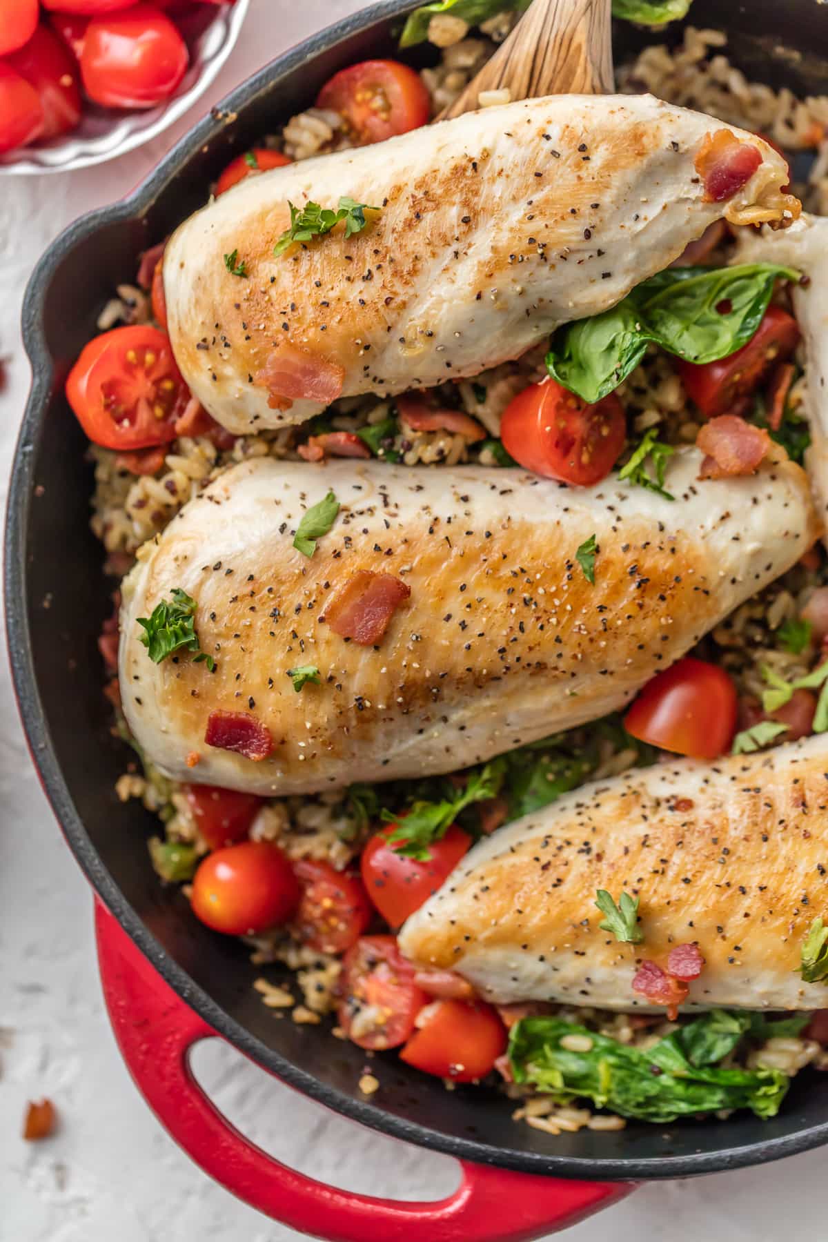 Spinach, bacon, tomato, chicken and rice recipe in a skillet