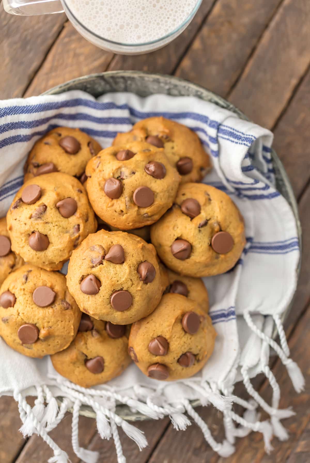 APPLESAUCE CHOCOLATE CHIP COOKIES stacked on a blue and white dish towel