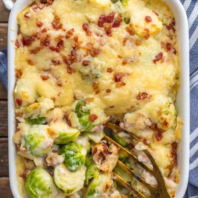 brussel sprouts gratin in white serving dish with spatula