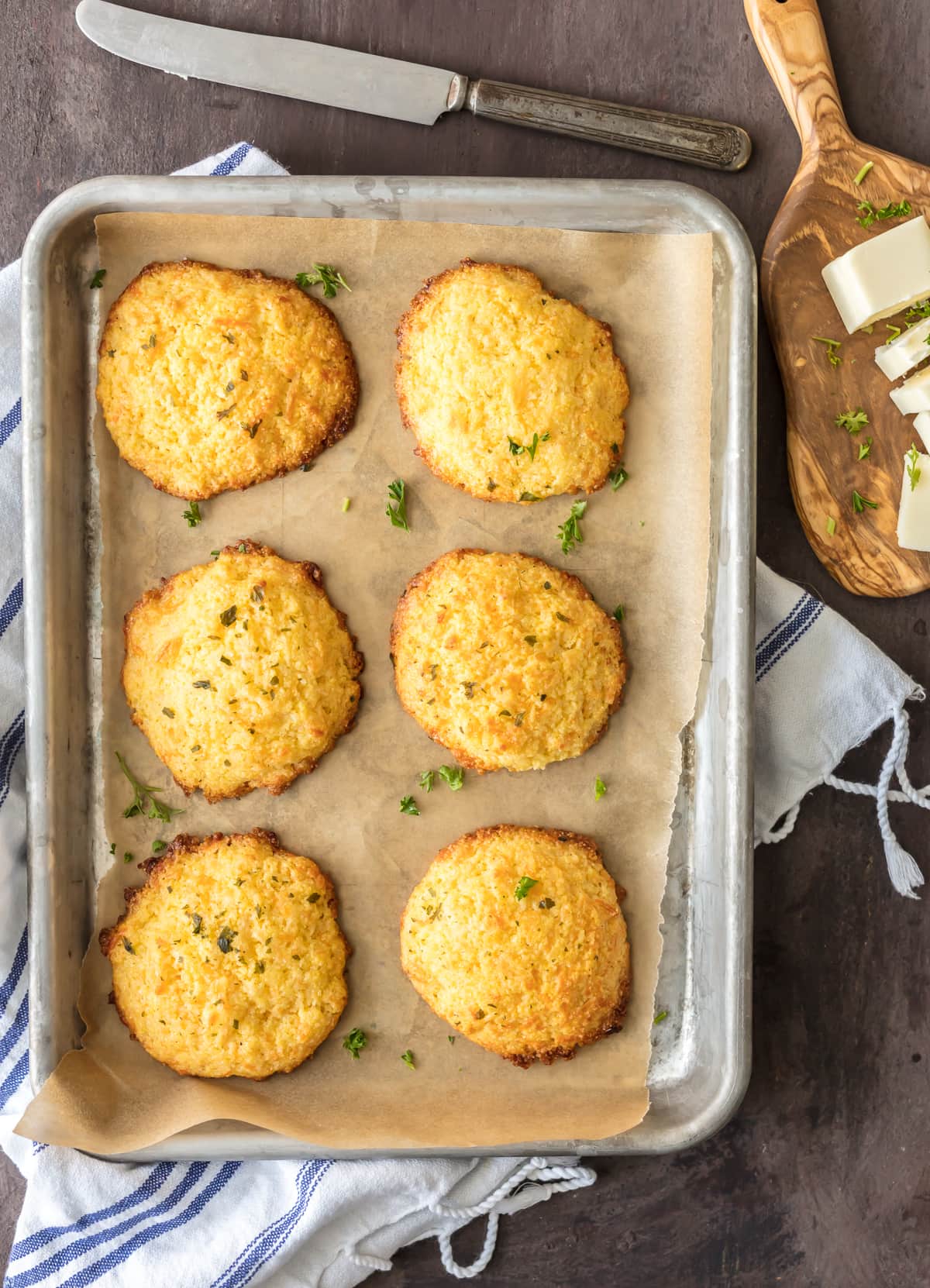 Cornbread drop biscuits on a baking sheet lined with parchment paper