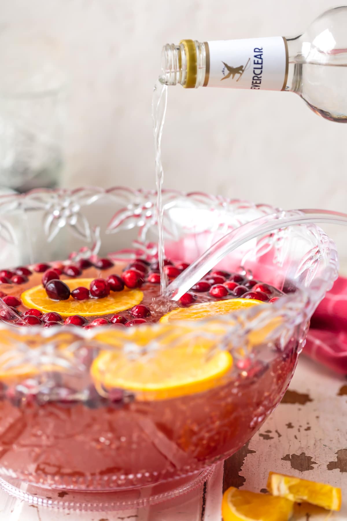 pouring vodka into christmas punch