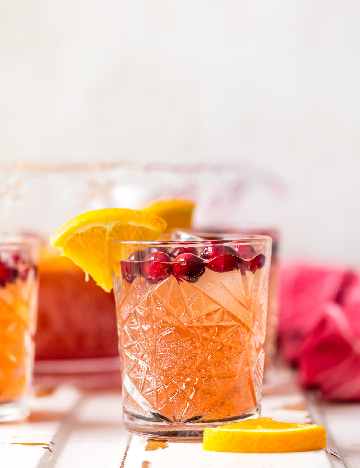 A glass filled with cranberry orange holiday punch recipe