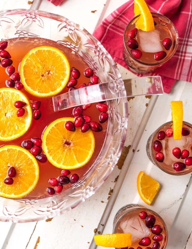 Holiday Punch is one of our favorite EASY PUNCH RECIPES perfect for Thanksgiving or Christmas! This Vodka punch is made with Cranberry Juice, Orange Juice, Ginger Ale, Sparkling Cider and more! You can pour in the Vodka or make it your new Non Alcoholic Christmas Punch Recipe. One of our very favorite Holiday Punch Recipes.