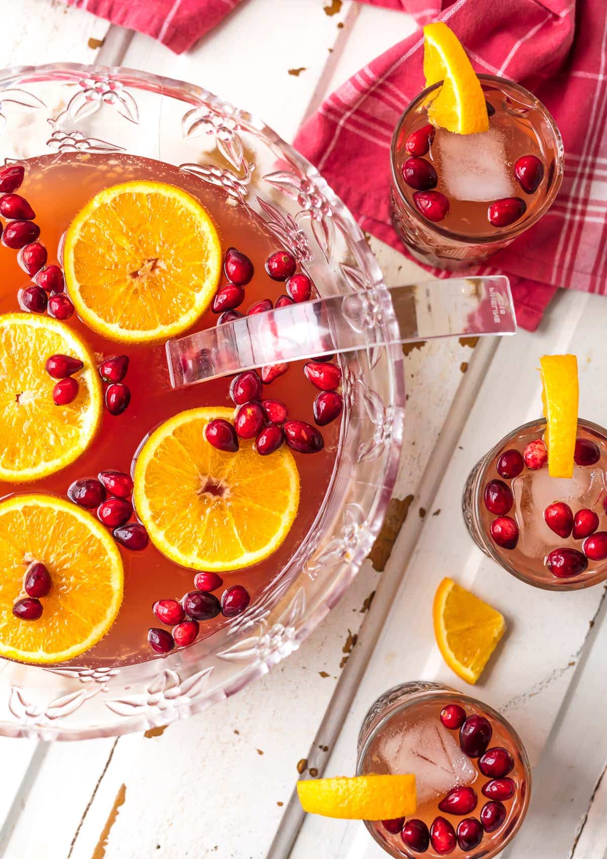 Holiday Punch served in a large punch bowl with cranberries and oranges