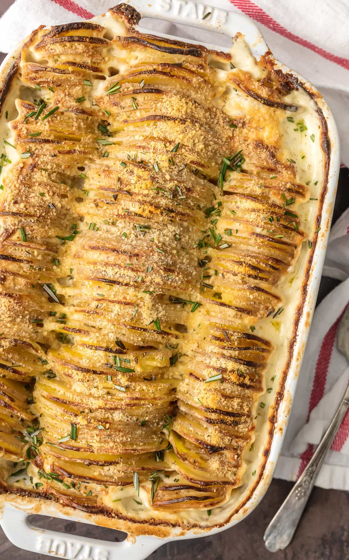 These CHEESY GARLIC HERB SCALLOPED POTATOES are one of our favorite holiday side dishes! Made creamy with a secret ingredient that you'll never skip again! Beautiful and delicious potatoes gratin!