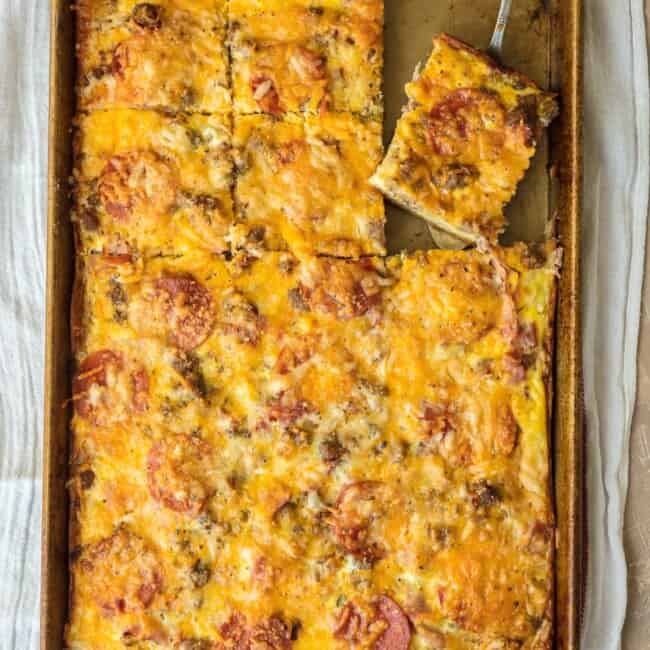 MEAT LOVERS BREAKFAST PIZZA is the perfect Christmas morning breakfast recipe! Loaded with pepperoni, bacon, sausage, hamburger, egg, hash browns, and cheese! BEST SHEET PAN BREAKFAST PIZZA EVER!