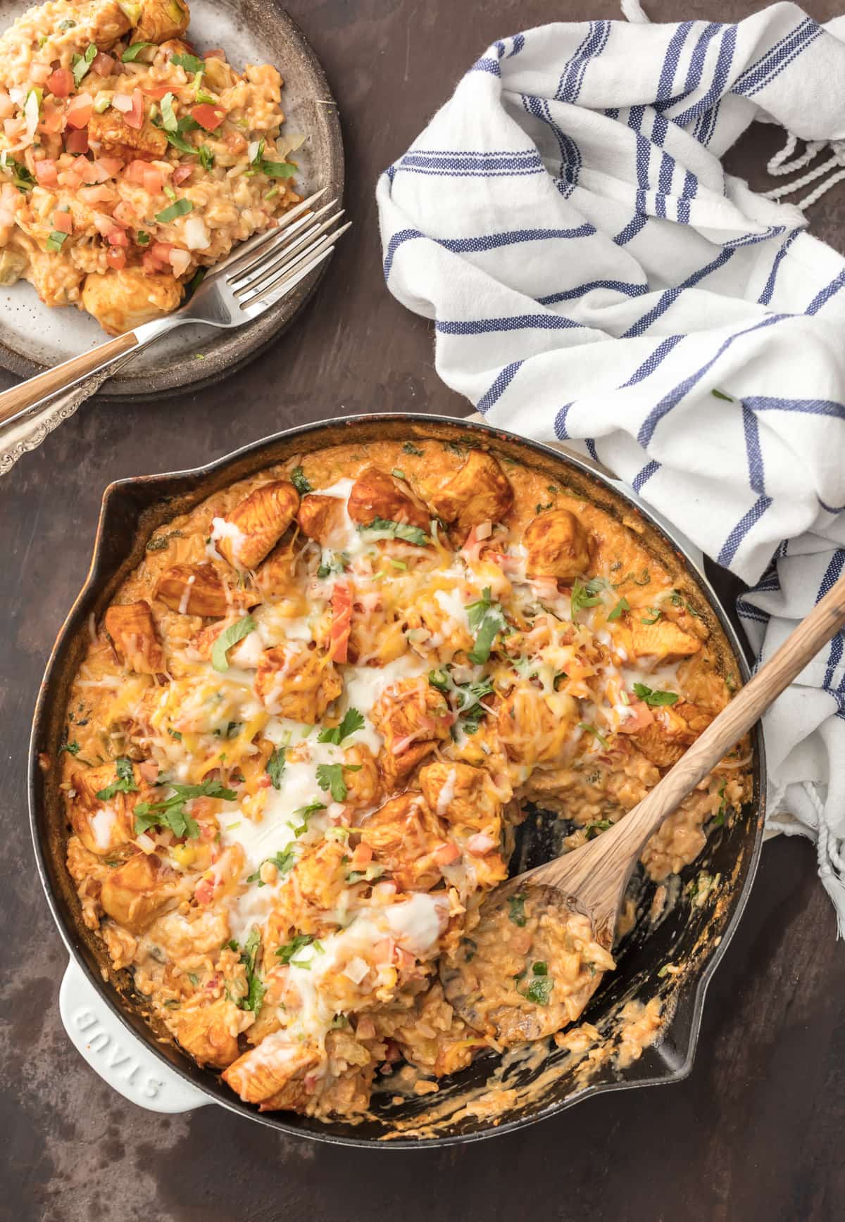 skillet filled with chicken, cheese, rice, and more