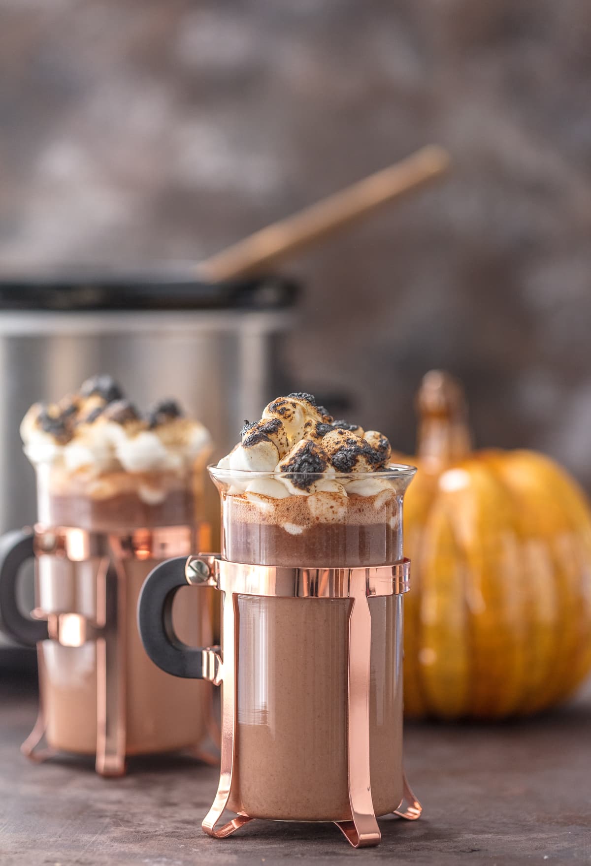 Spiked Pumpkin Spice Hot Chocolate in glass mugs, topped with toasted marshmallows 