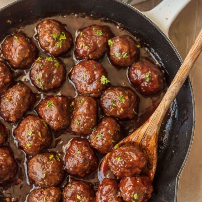 meatballs in a skillet with wooden spoon