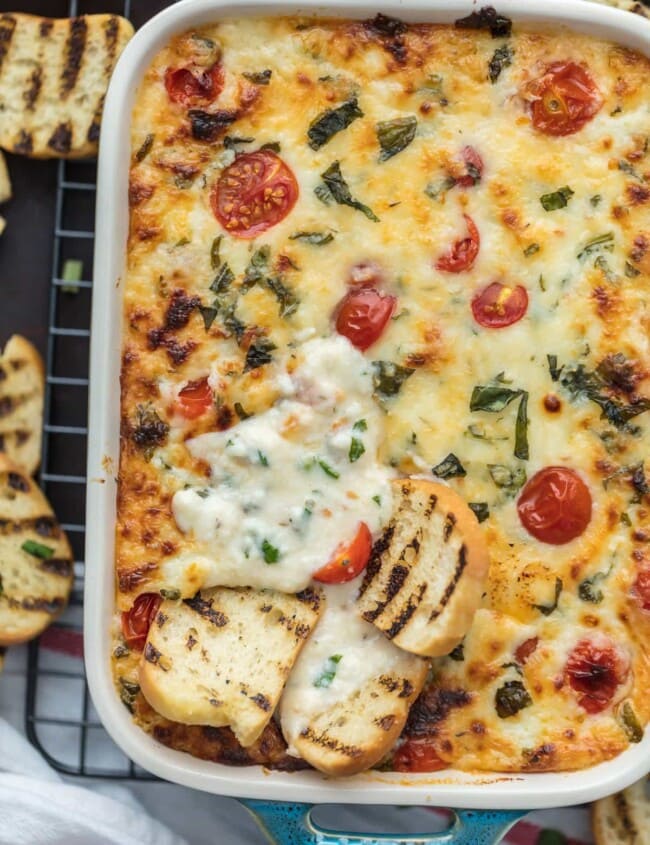 Tomato Mozzarella Caprese Dip is the ultimate EASY party dip for any occasion! This cheesy dip is perfect for any celebration, tailgating, and especially the Super Bowl. Best cheese dip recipe ever!