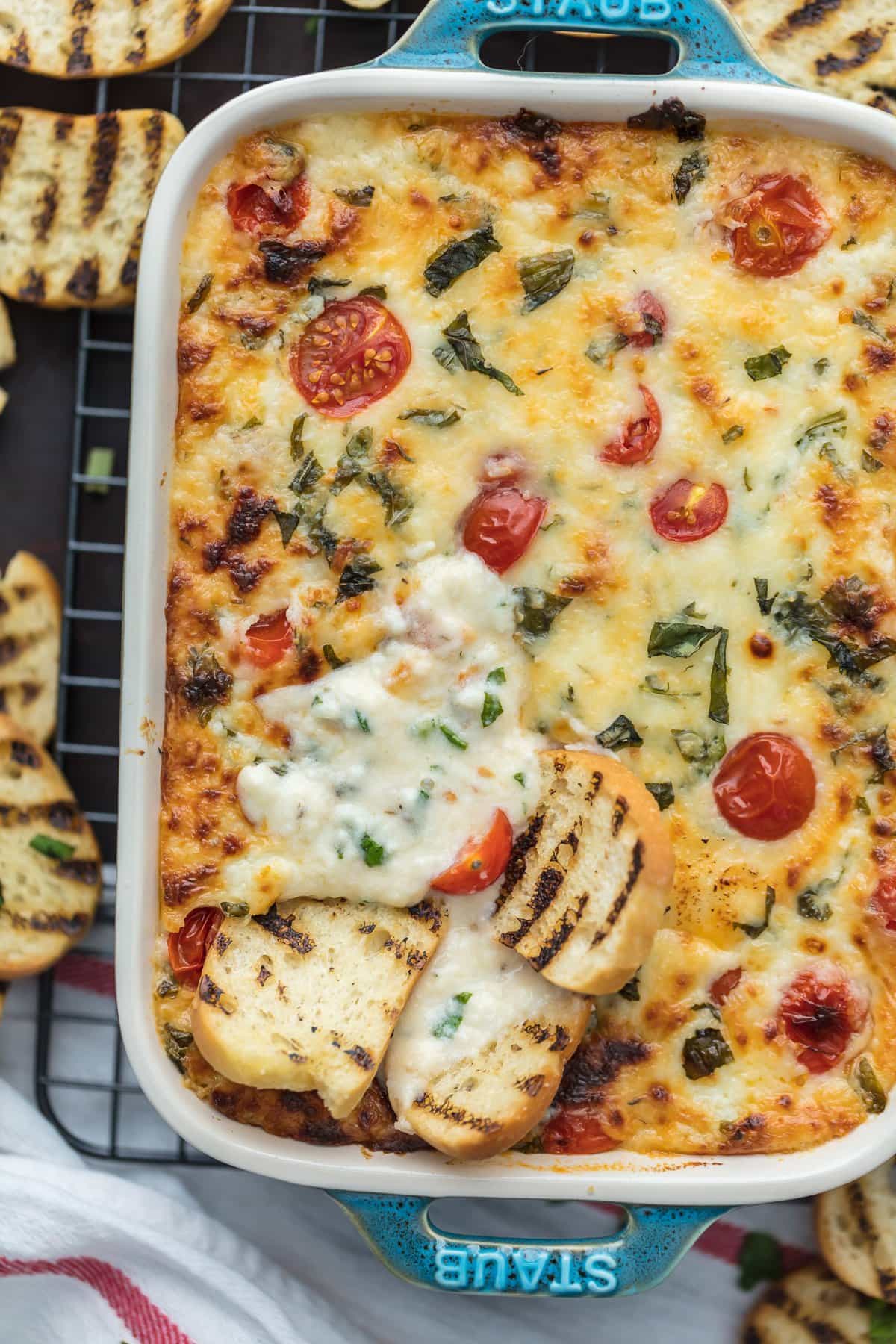 Baked cheese dip with tomatoes, mozzarella, and basil