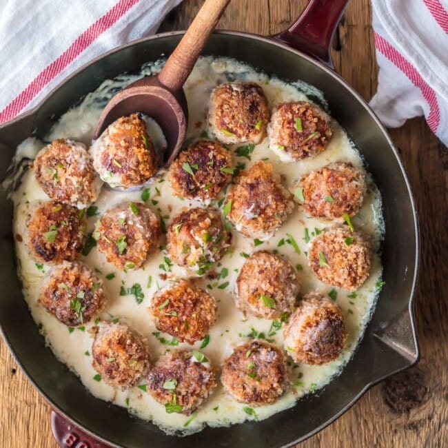 CHICKEN CORDON BLEU MEATBALLS are the most amazing holiday appetizer ever! Chicken meatballs stuffed with swiss and ham, and cooked in a white wine dijon sauce. I could eat these Cordon Bleu Chicken Meatballs for every meal!