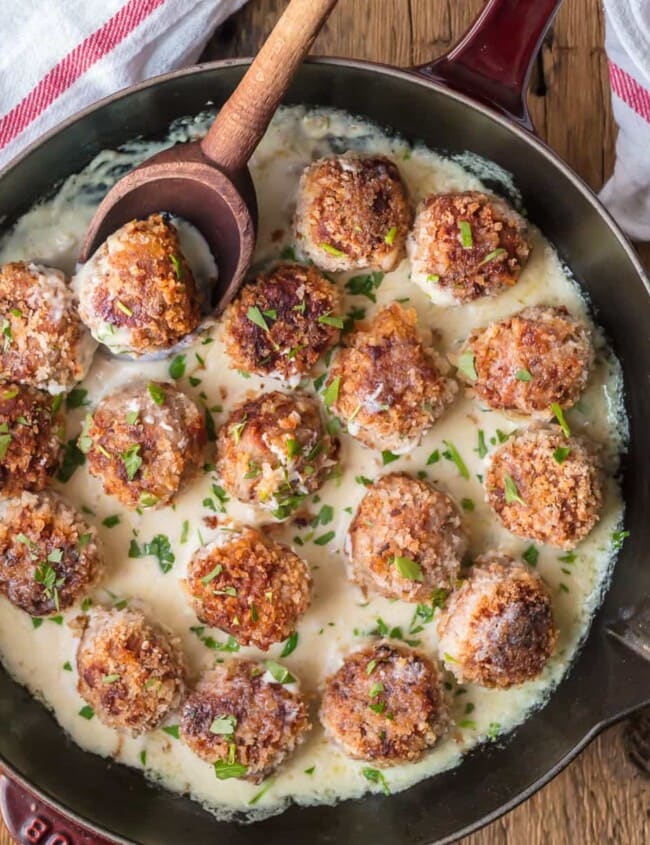 CHICKEN CORDON BLEU MEATBALLS are the most amazing holiday appetizer ever! Chicken meatballs stuffed with swiss and ham, and cooked in a white wine dijon sauce. I could eat these Cordon Bleu Chicken Meatballs for every meal!