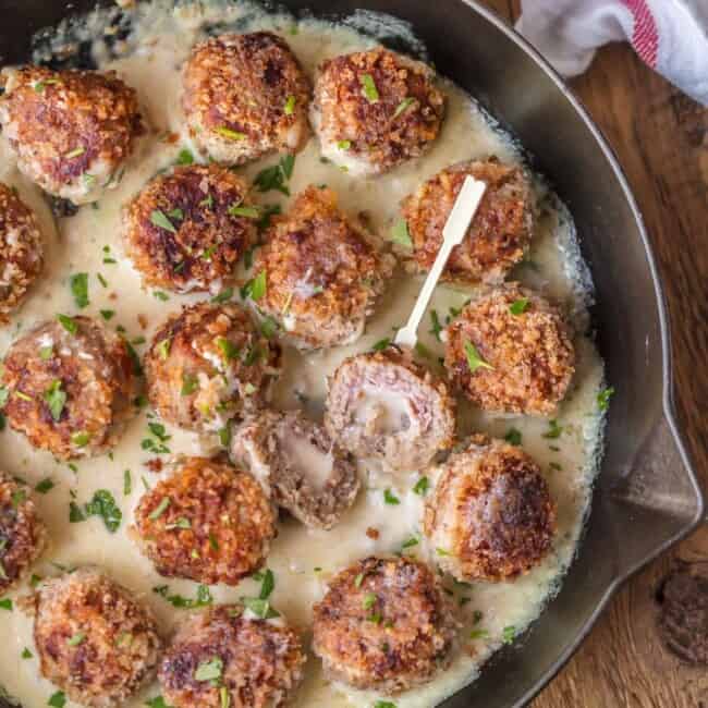 CHICKEN CORDON BLEU MEATBALLS, the most amazing holiday appetizer ever! Chicken meatballs stuffed with swiss and ham and cooked in a white wine dijon sauce. I could eat these for every meal!