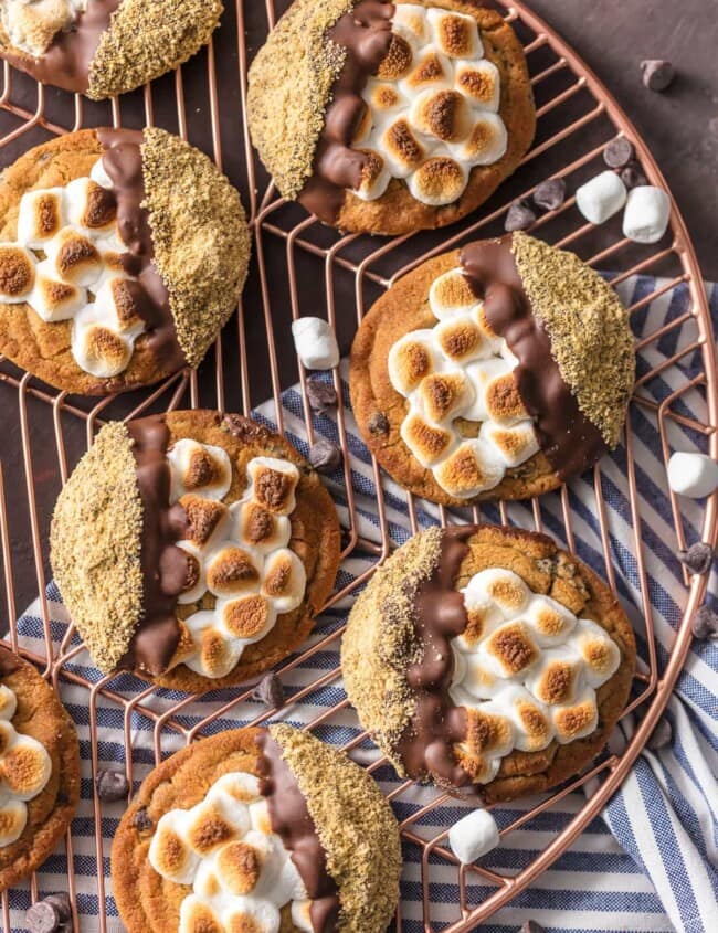 S'mores Cookies are one of the BEST Easy Cookie Recipes I have ever made (or tried!). These Easy Smores Cookies are a favorite at our house for Christmas or any time of year. It can be our little secret that they're made with pre-made refrigerated chocolate chip cookie dough, dipped in milk chocolate, then graham cracker crumbs. Everything you love about S'mores in cookie form. DIVINE! Easy S'more Cookies for the win!