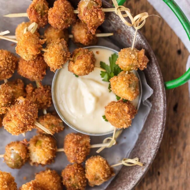 These FRIED BLUE CHEESE STUFFED OLIVES are just delicious. And when served with a simple garlic aioli sauce, they are absolutely addicting! These fried and stuffed olives are the perfect holiday appetizer, just what you need for Christmas or New Year's Eve!