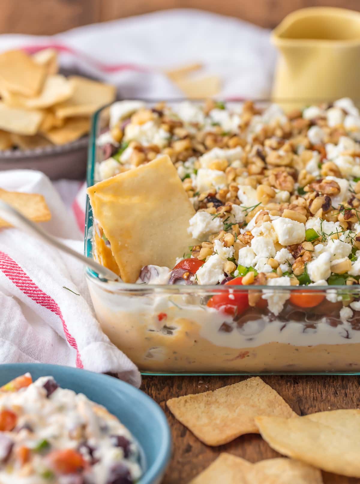 7 Layer Greek Dip in a clear baking dish