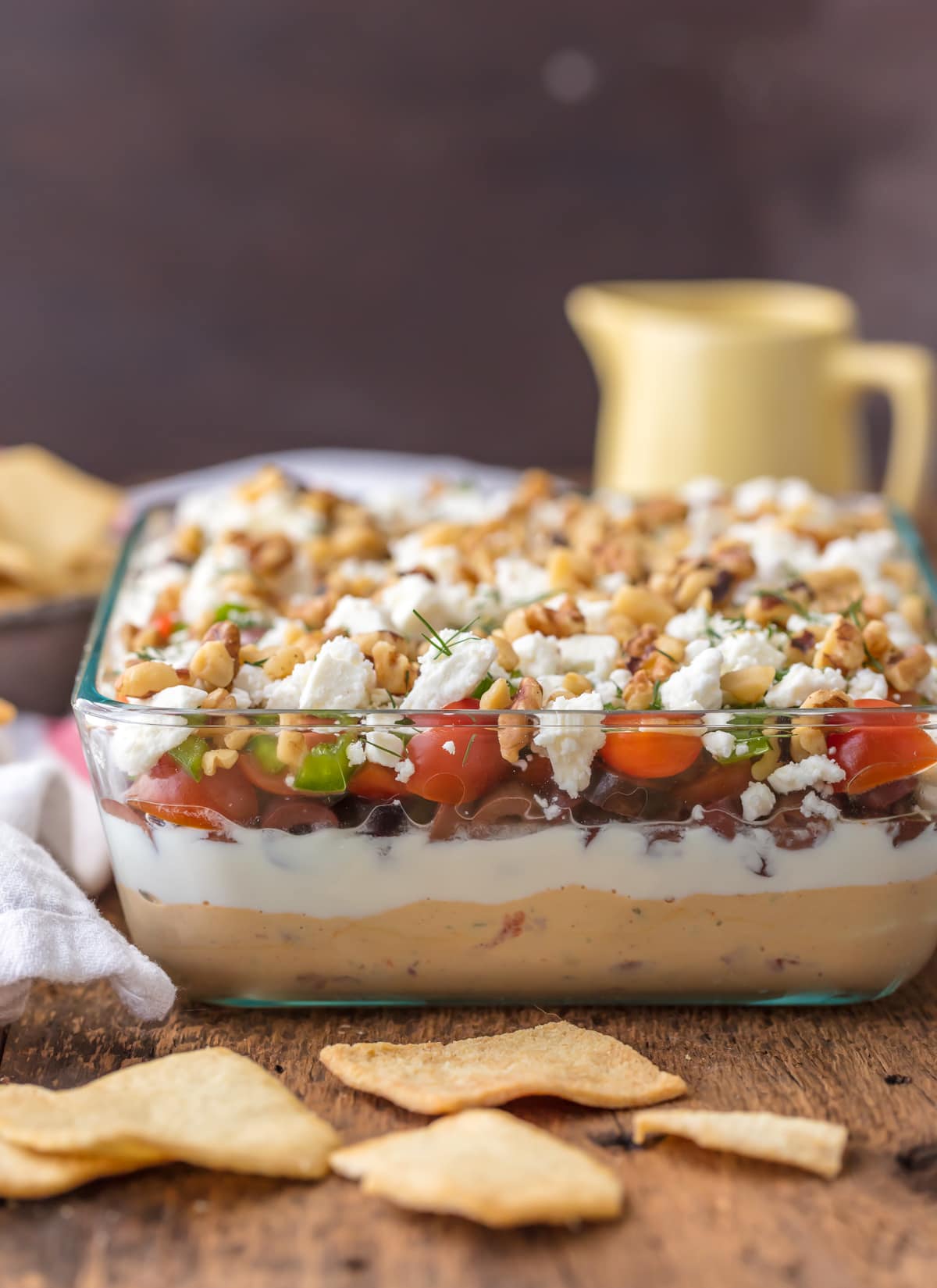 7 layer dip: hummus, yogurt, olives, tomatoes, peppers, feta, walnuts