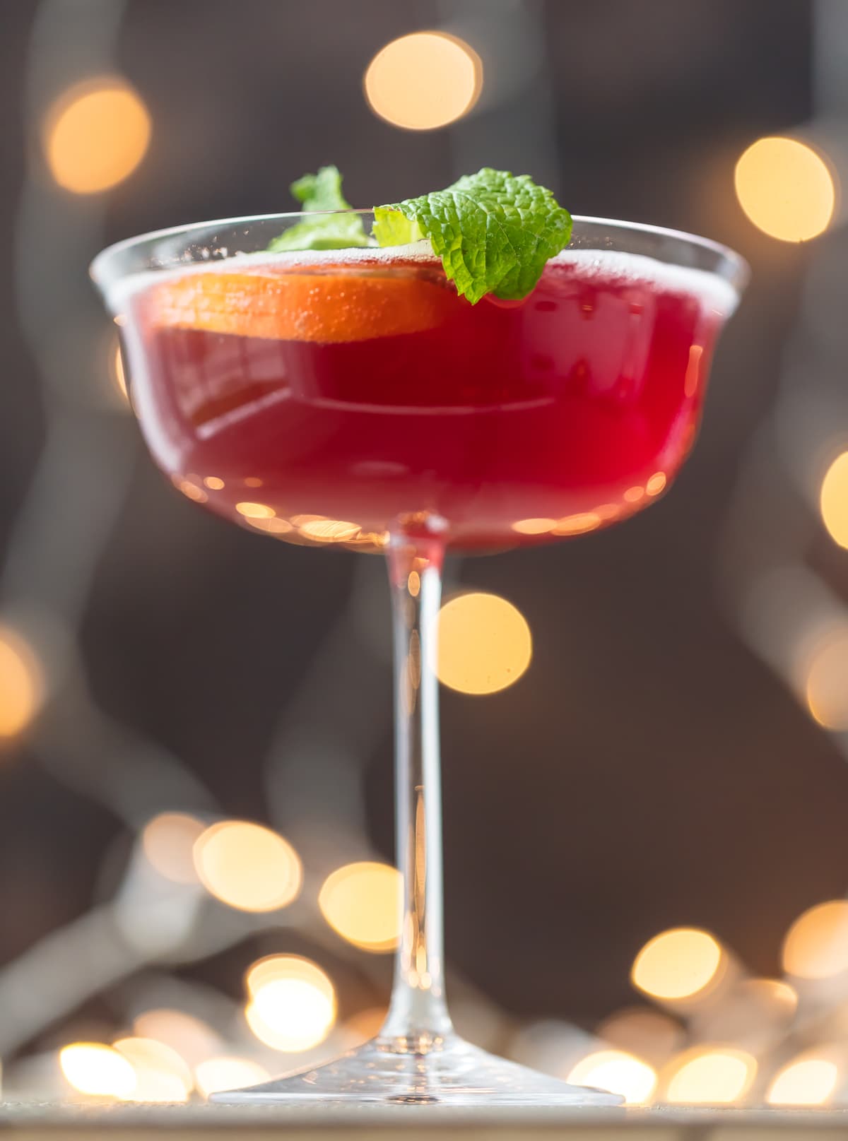 Red holiday cocktail in a long stem glass