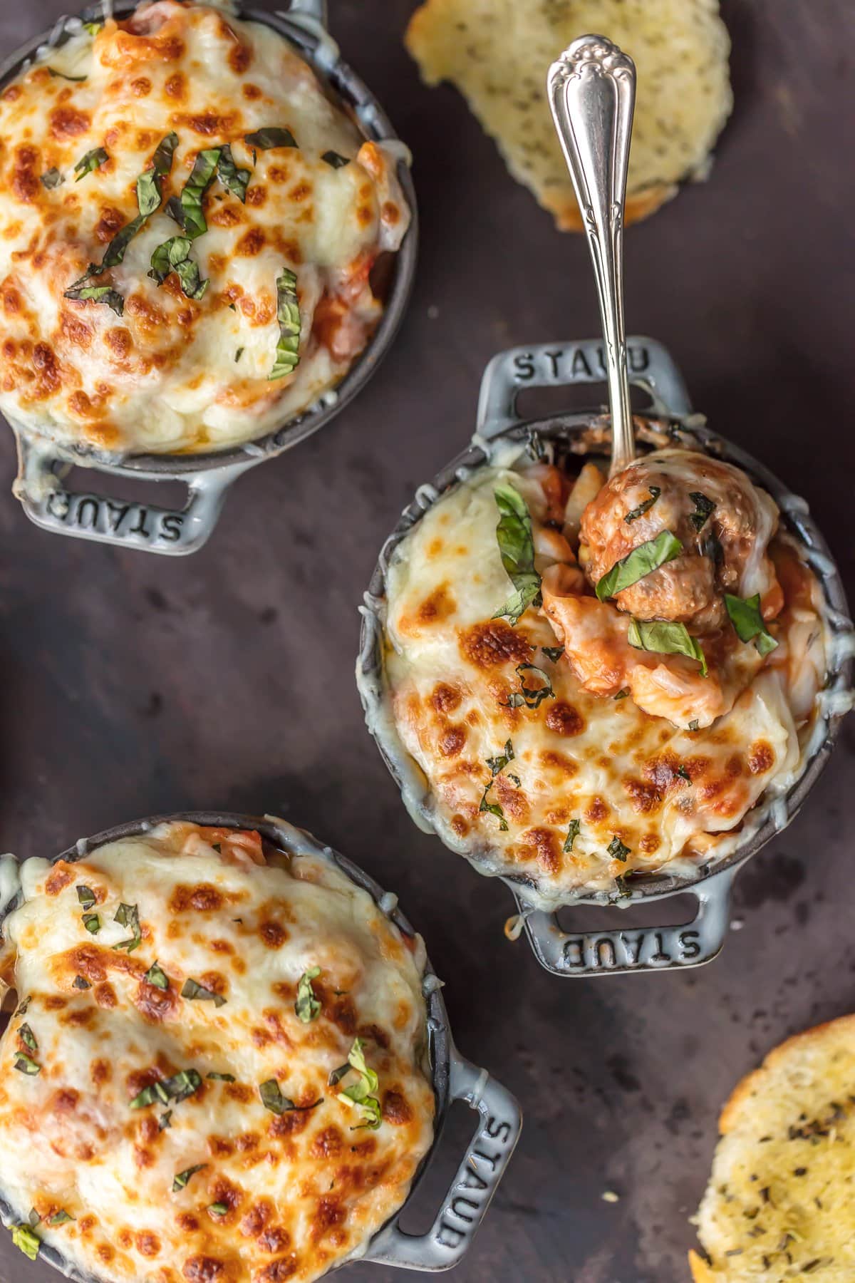 Cheesy Meatball Soup in three bowls, topped with melted cheese