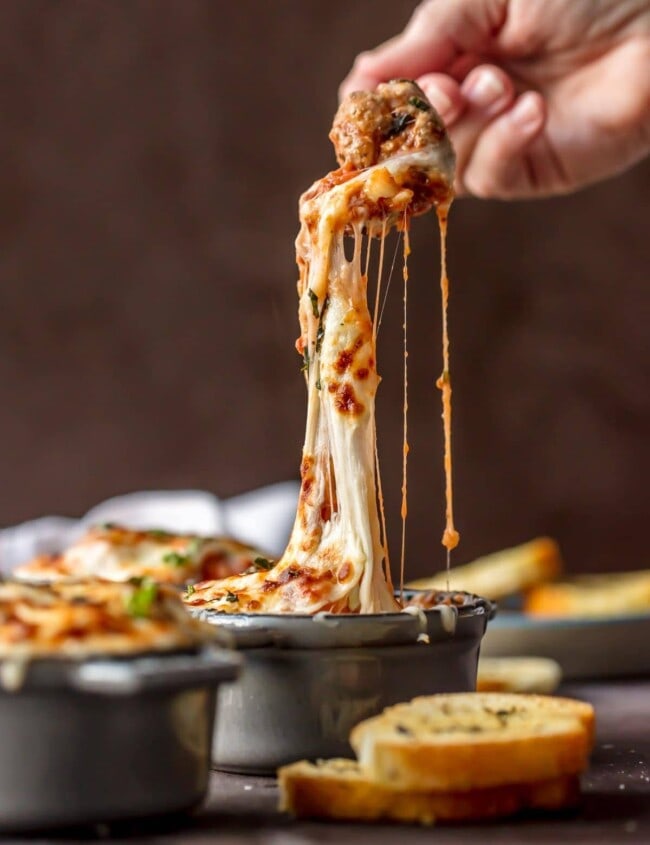 Parmesan Meatball Soup is the ultimate comfort food! This cheesy, hearty Meatball Parmesan Soup topped with melted cheese and basil just might be the best soup you've had all year!