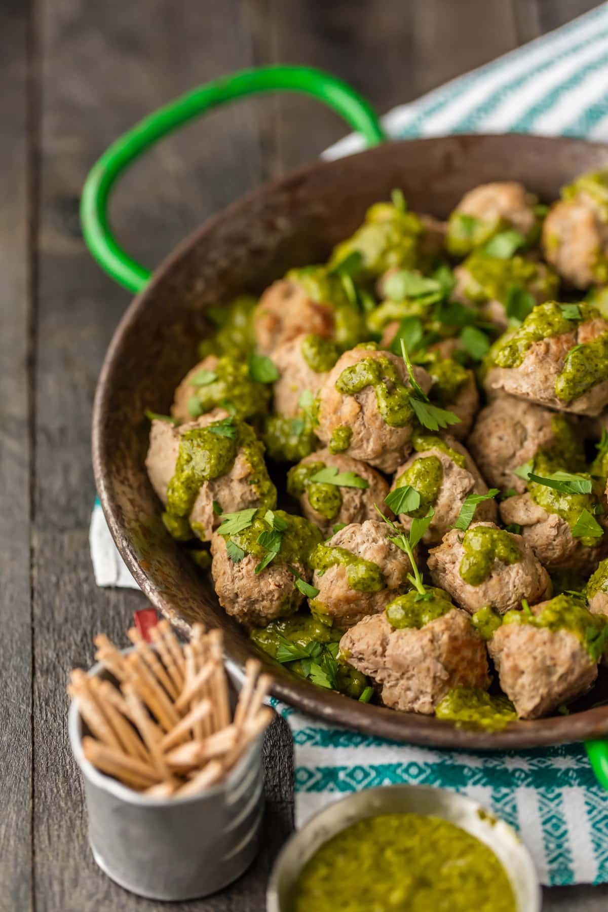 Easy Drop Meatballs on a serving platter, with green sauce