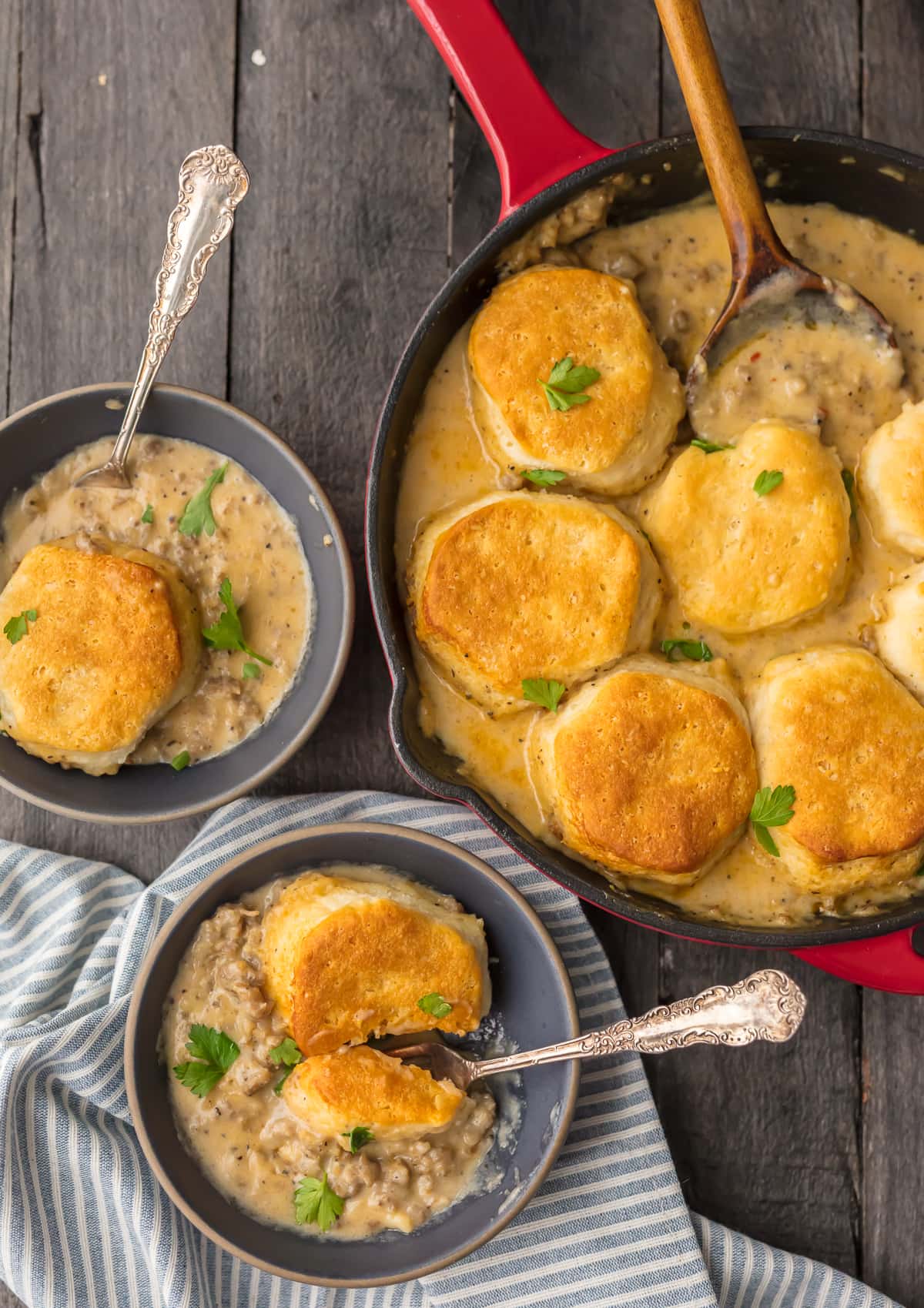 Sausage Biscuit Gravy Cobbler in a skillet, next to two bowls 