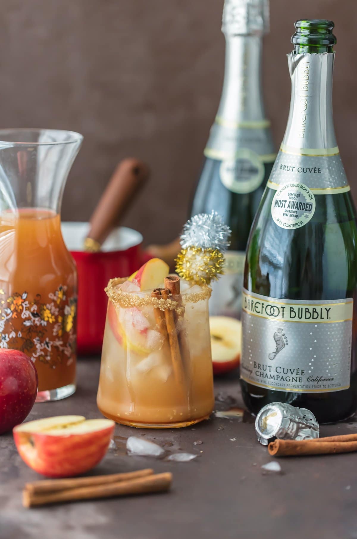 Sparkling Apple Pie on the Rocks next to bottle of champagne