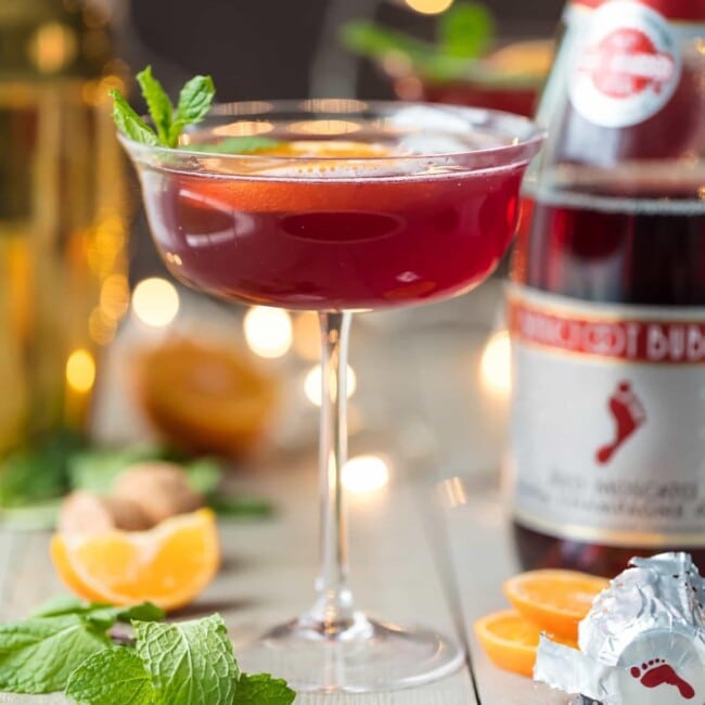 Flirtinis are a fun drink perfect for festive occasions. This Sparkling Holiday Flirtini is so fun, so pretty, and so delicious! It's made from cranberry and pineapple juice mixed with orange vodka, and topped off with red Moscato champagne. It's the perfect holiday cocktail recipe for Christmas or New Year's Eve!