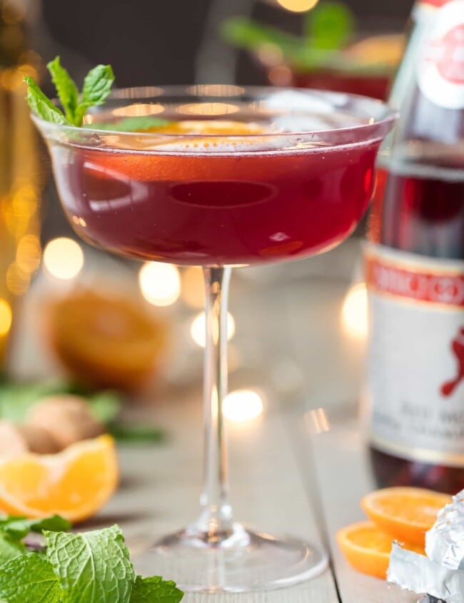 Flirtinis are a fun drink perfect for festive occasions. This Sparkling Holiday Flirtini is so fun, so pretty, and so delicious! It's made from cranberry and pineapple juice mixed with orange vodka, and topped off with red Moscato champagne. It's the perfect holiday cocktail recipe for Christmas or New Year's Eve!