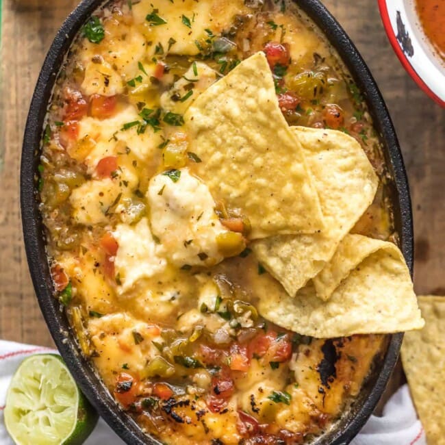 TEQUILA LIME FLAMING CHEESE DIP is the most fun way to eat cheese dip! This delicious queso is loaded with pico and green chiles, topped with a chili lime reduction, and then doused in tequila and lit on fire. It's the ultimate New Year's Eve or Super Bowl appetizer!