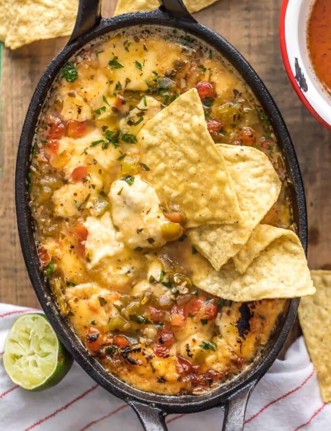 TEQUILA LIME FLAMING CHEESE DIP is the most fun way to eat cheese dip! This delicious queso is loaded with pico and green chiles, topped with a chili lime reduction, and then doused in tequila and lit on fire. It's the ultimate New Year's Eve or Super Bowl appetizer!