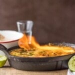 flaming queso dip in a pan