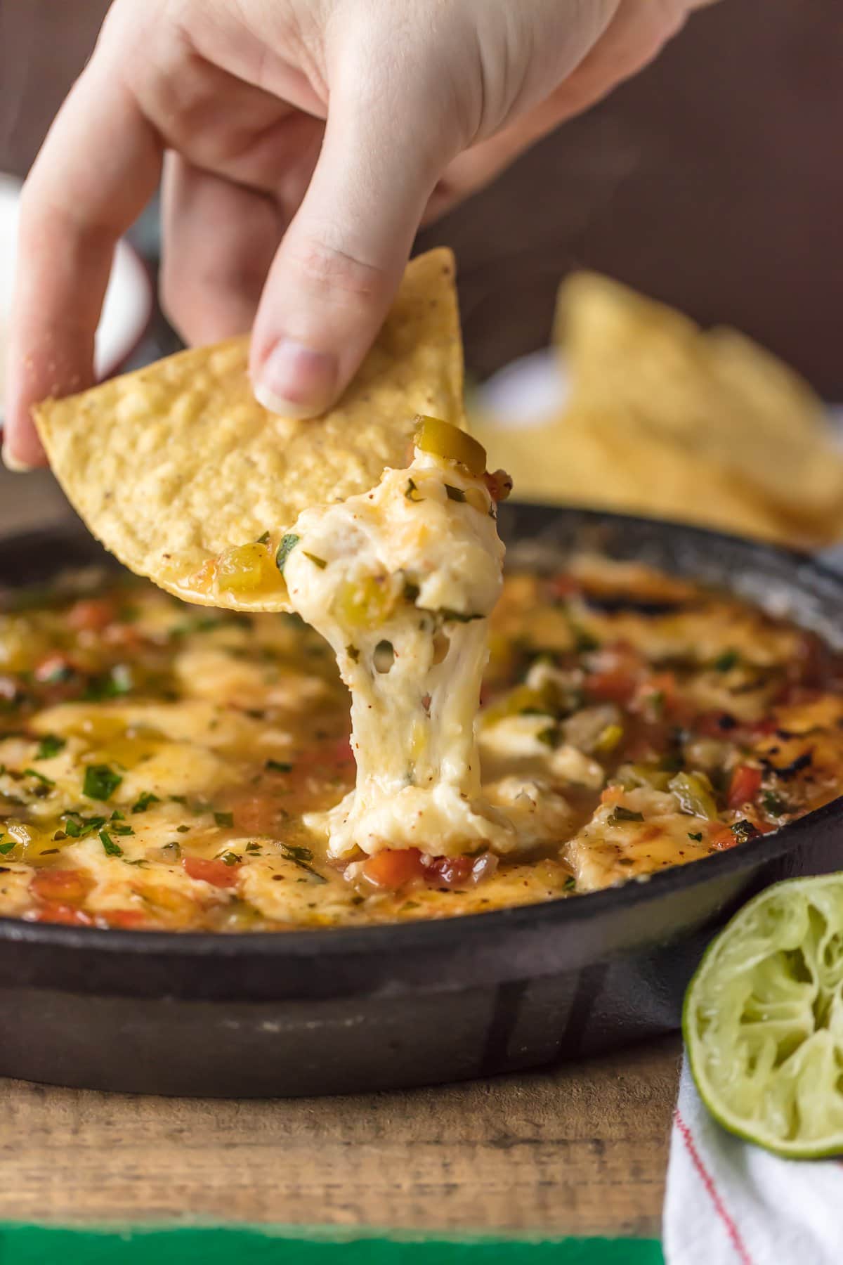 Dipping a tortilla chip into flaming cheese dip