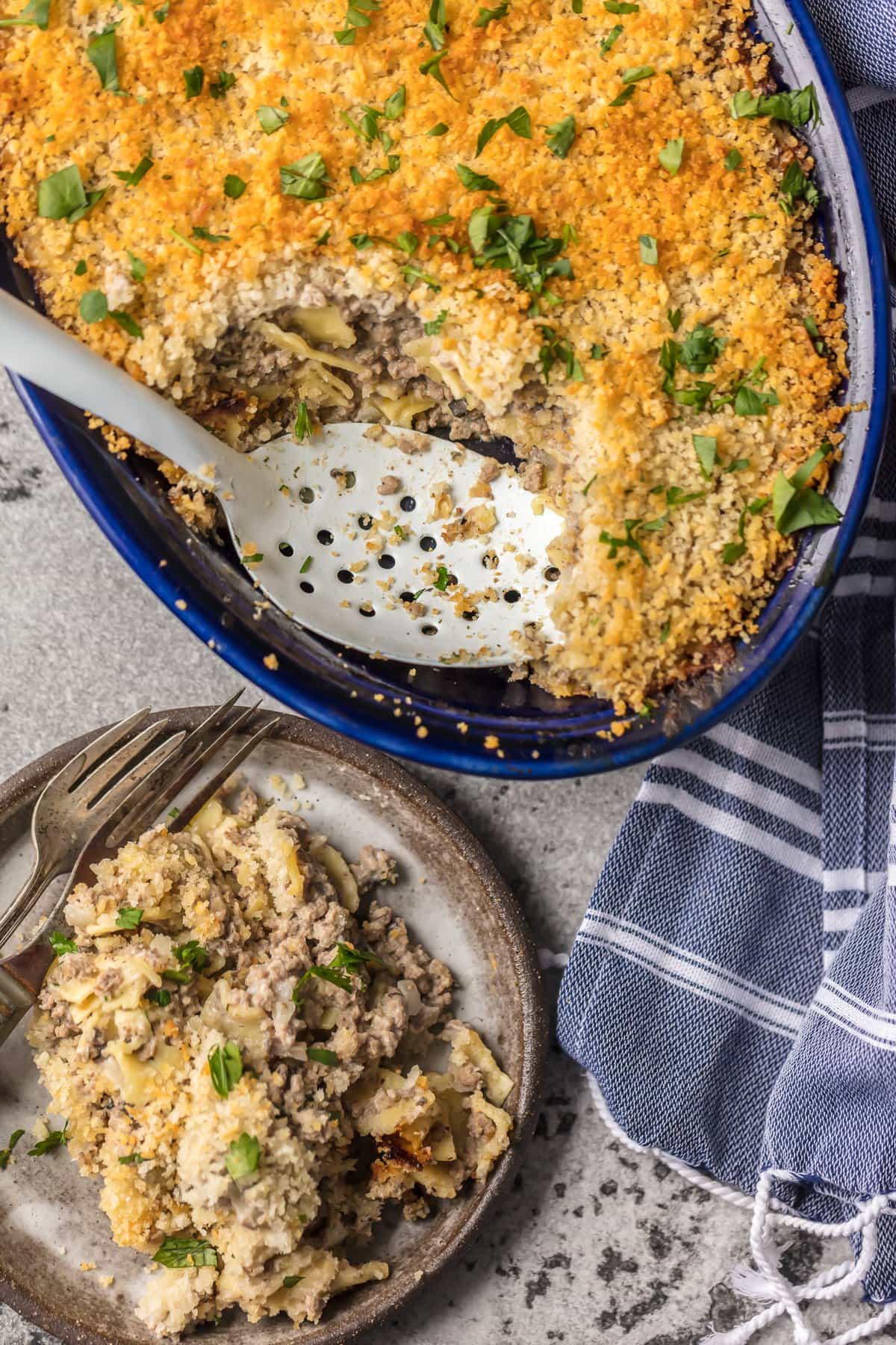 A plate of beef stroganoff casserole next to the casserole dish