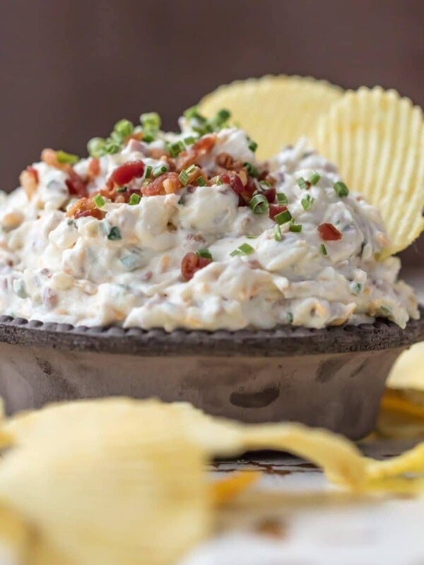 CARAMELIZED ONION DIP is the ultimate super easy appetizer to make for game day! This amazing sour cream and bacon dip is made in minutes and loved by all. It's filled with so much flavor, and so many delicious ingredients, like bacon, sour cream, onions, and chives.