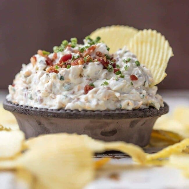 CARAMELIZED ONION DIP is the ultimate super easy appetizer to make for game day! This amazing sour cream and bacon dip is made in minutes and loved by all. It's filled with so much flavor, and so many delicious ingredients, like bacon, sour cream, onions, and chives.