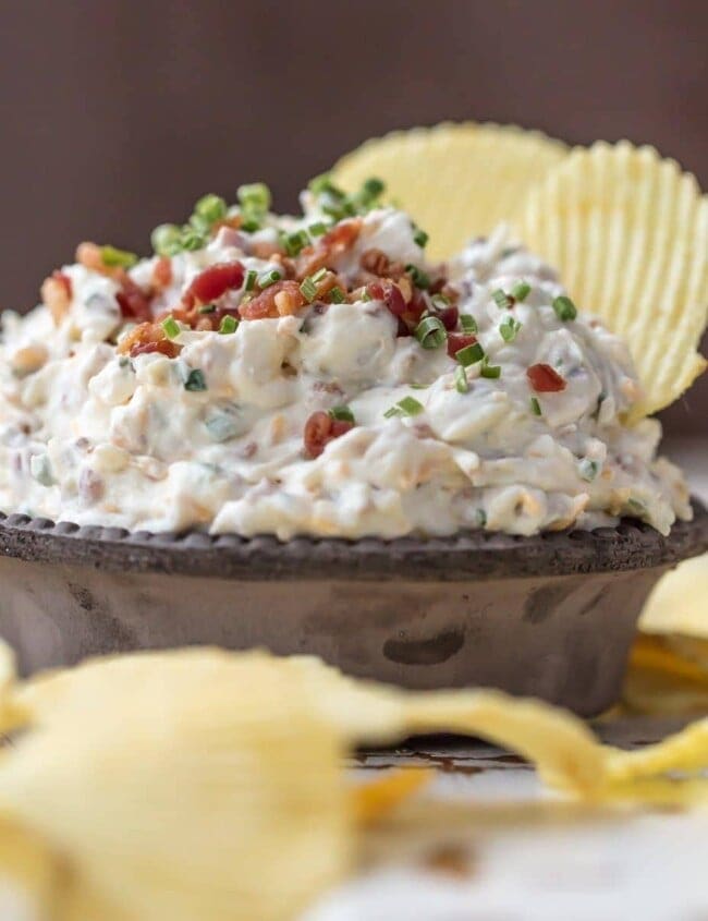 CARAMELIZED ONION DIP is the ultimate super easy appetizer to make for game day! This amazing sour cream and bacon dip is made in minutes and loved by all. It's filled with so much flavor, and so many delicious ingredients, like bacon, sour cream, onions, and chives.