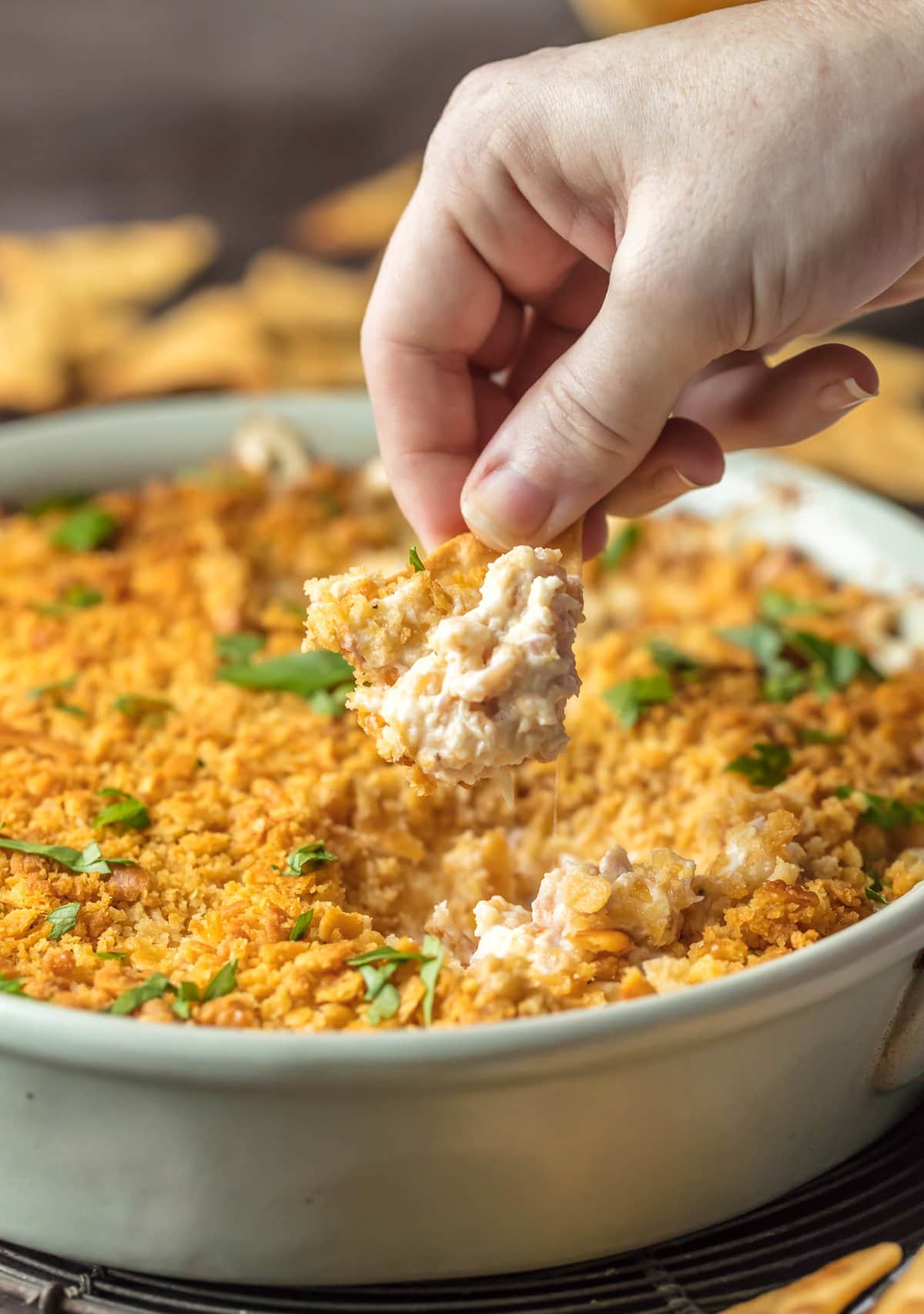 Dipping a cracker into chicken cordon bleu dip