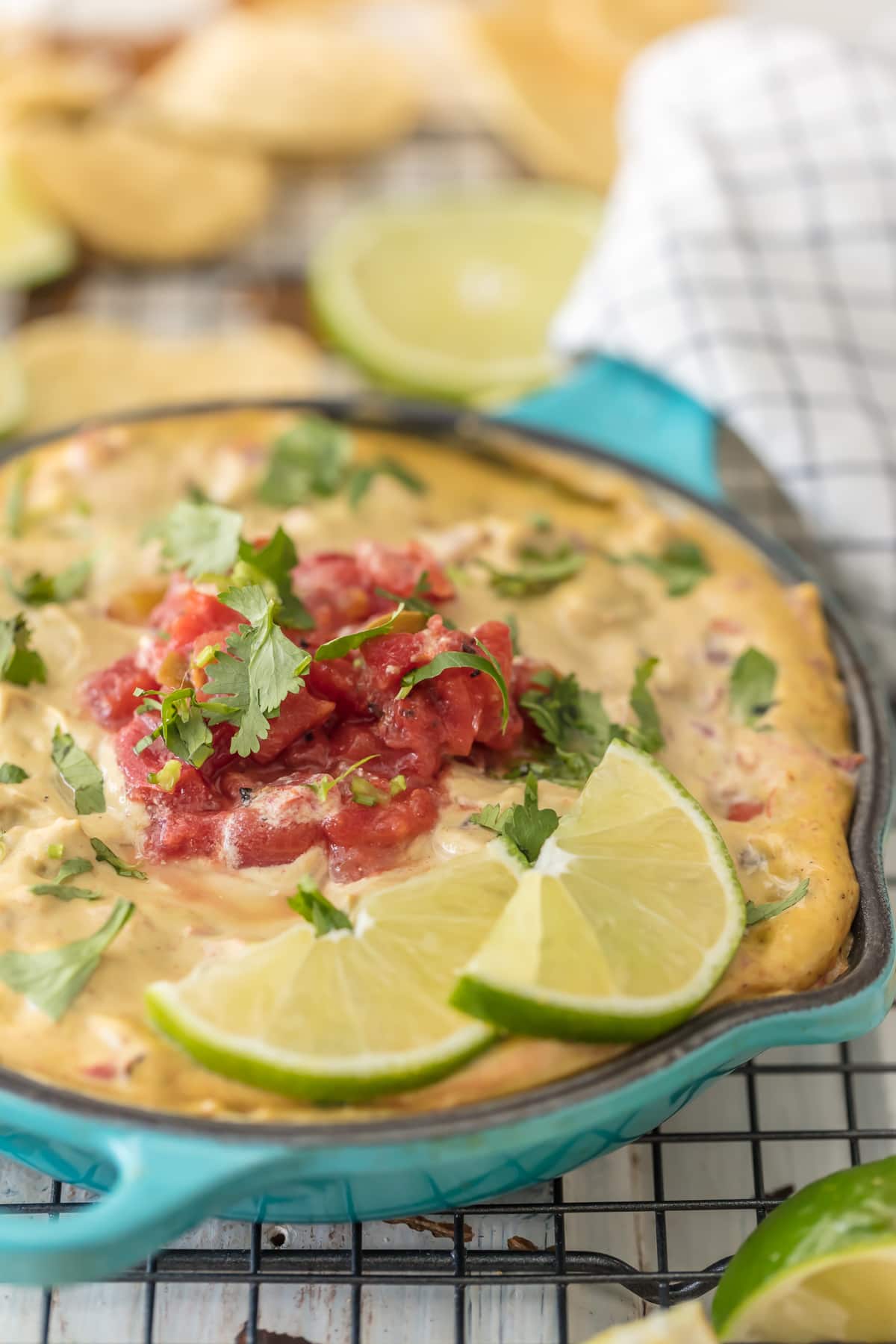 Vegan Queso topped with rotel, lime wedges and cilantro
