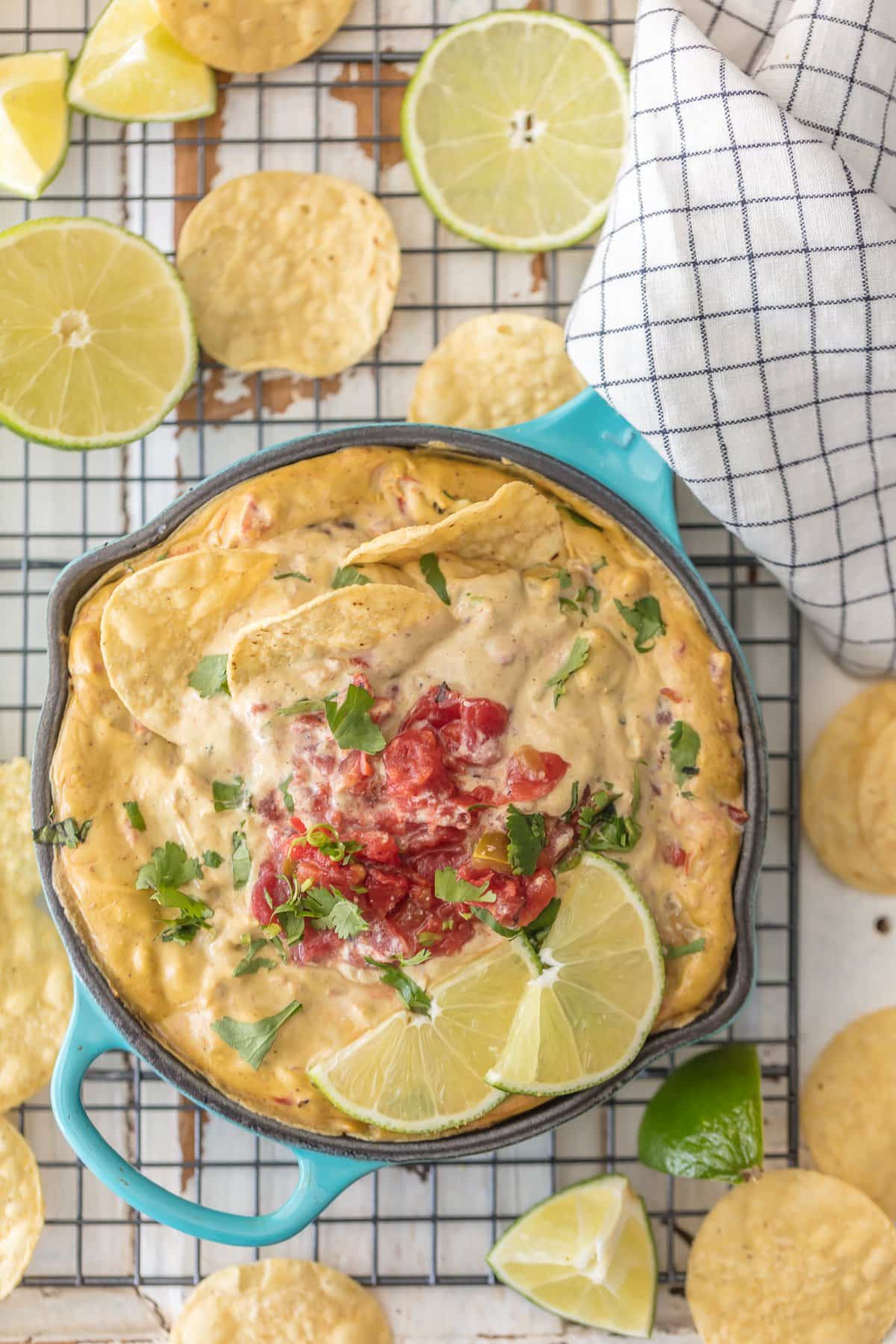 Vegan Queso topped with rotel, lime wedges, and tortilla chips