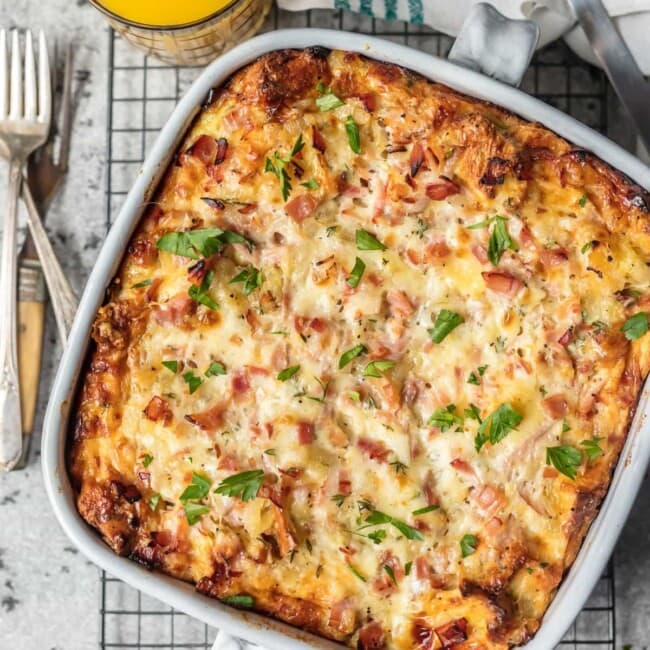 This HAM AND CHEESE BREAKFAST CASSEROLE is our favorite make ahead breakfast for any special occasion. Loaded with ham, cheese, , bread, eggs, herbs, and more! Sure to please everyone and just so easy to make!
