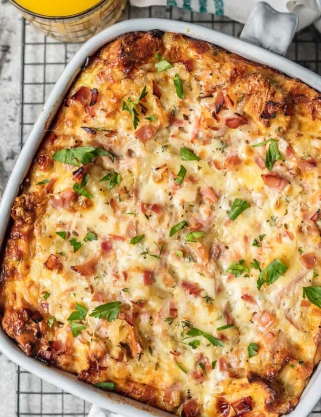 This HAM AND CHEESE BREAKFAST CASSEROLE is our favorite make ahead breakfast for any special occasion. Loaded with ham, cheese, , bread, eggs, herbs, and more! Sure to please everyone and just so easy to make!