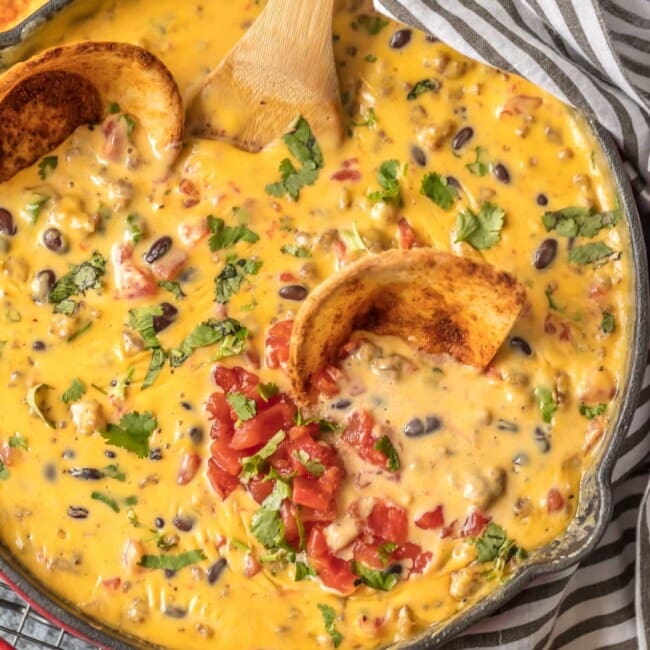 LOADED COWBOY QUESO is the ultimate Super Bowl dip! This EASY appetizer is loaded with velveeta, pepper jack, black beans, Rotel, and sausage! OUR FAVORITE TAILGATING DIP RECIPE!