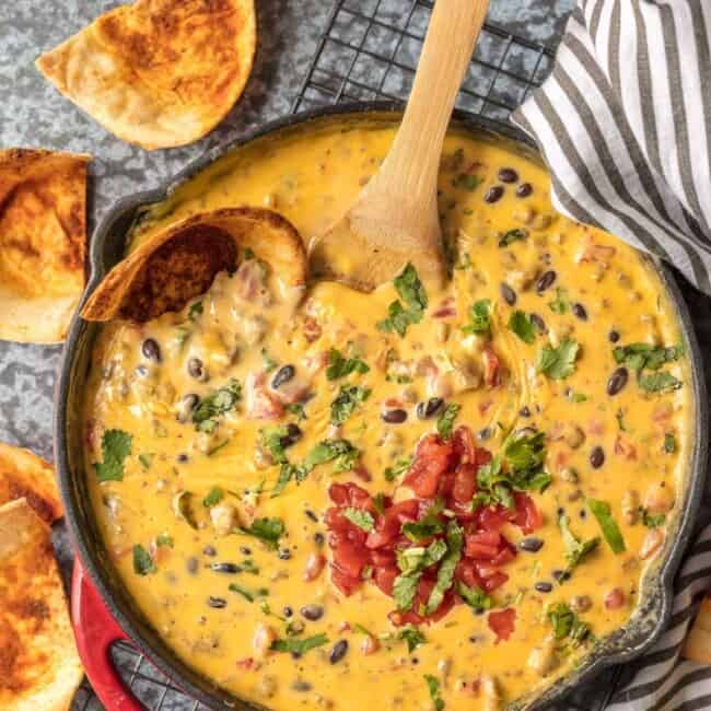 Cowboy Dip Queso (Loaded Velveeta Queso Dip) is the ultimate Super Bowl appetizer. This EASY Rotel Dip recipe is loaded with Velveeta, beer, pepper jack, black beans, Rotel, and sausage!