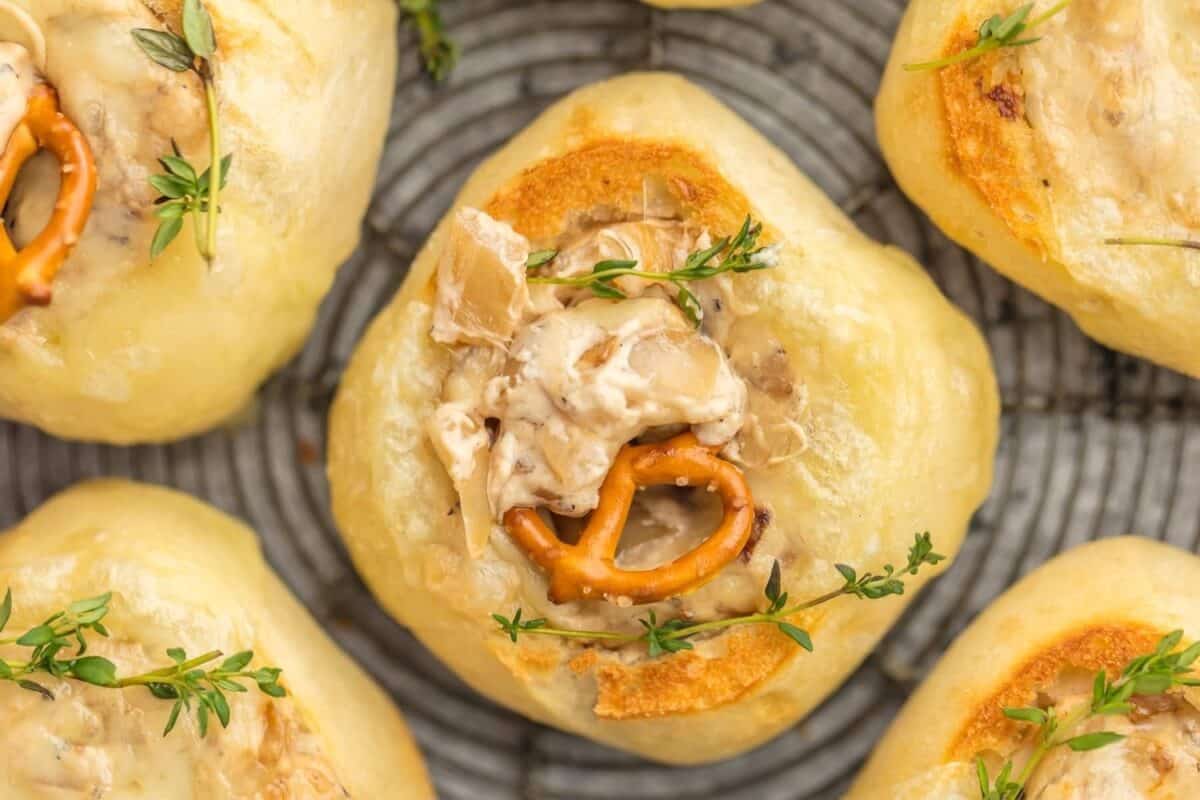 FRENCH ONION DIP is a classic appetizer that should be present at every party. We made this dip even more fun by making it in mini bread bowls! Making bread bowls with fresh rolls is easy, and it makes the perfect appetizer for the Super Bowl. finished french onion dip in bread bowls