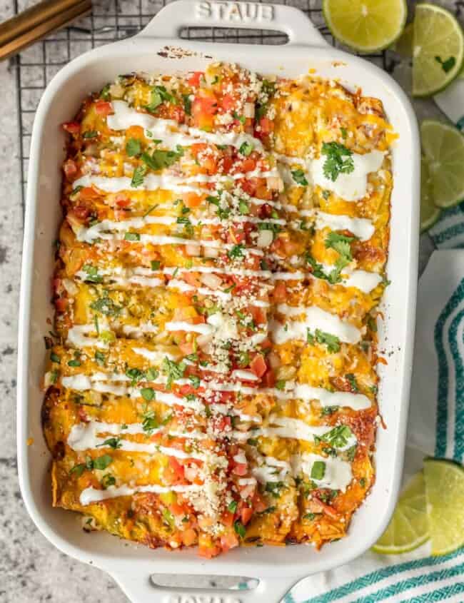 SALSA VERDE CHICKEN ENCHILADAS are a delicious and simple meal perfect for any occasion. They're stuffed with chicken, salsa verde, cheese, and topped with more sauce, cheese, onions, pico, and crema. The ultimate easy Mexican meal!