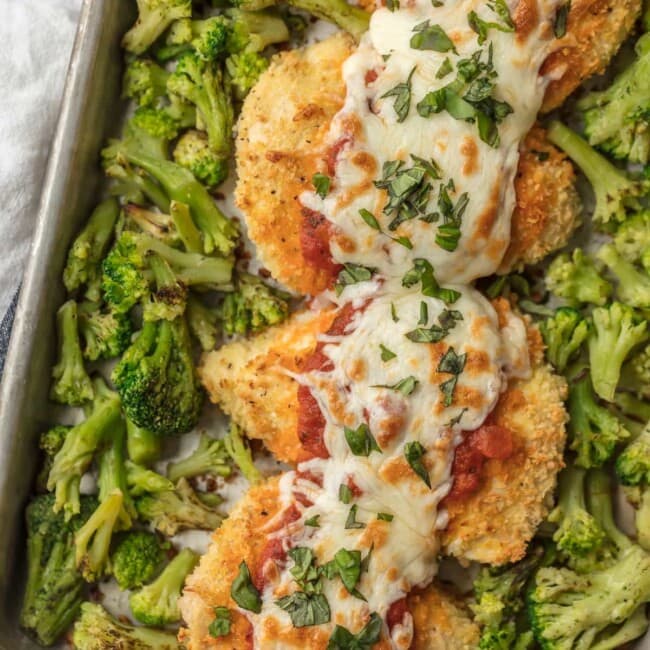 baked chicken parmesan on baking dish with broccoli