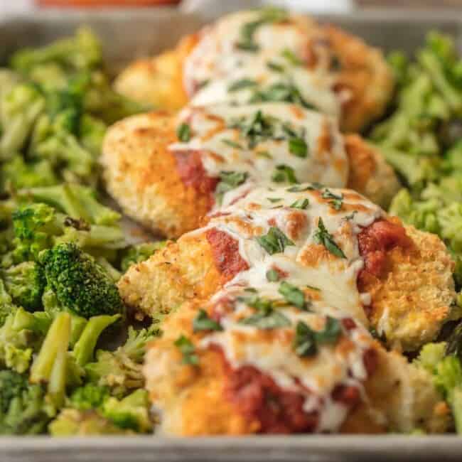 This amazing SHEET PAN CHICKEN PARMESAN with roasted broccoli and riced cauliflower is SO easy and an instant family favorite. Healthy Baked Chicken Parmesan topped with marinara, melty mozzarella, and fresh basil...what could be better?