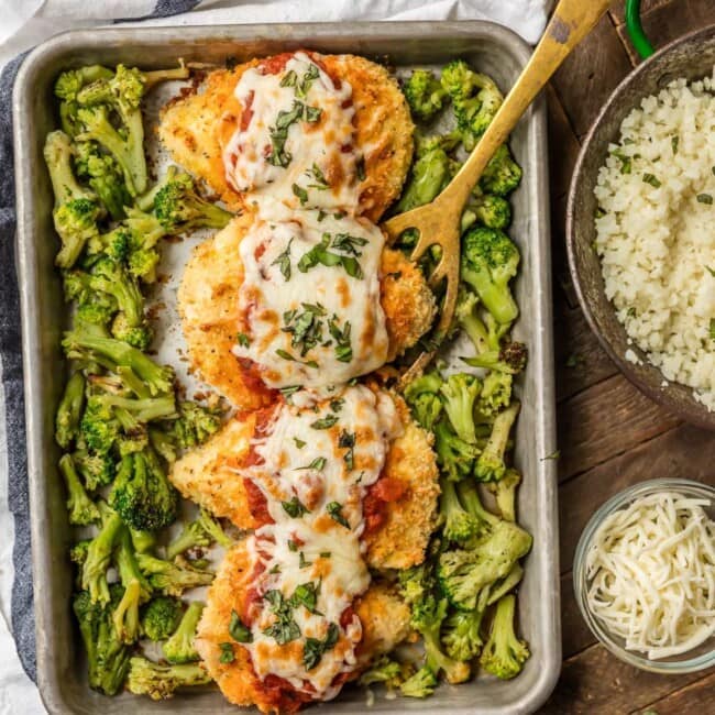 baked chicken parmesan on baking dish with broccoli